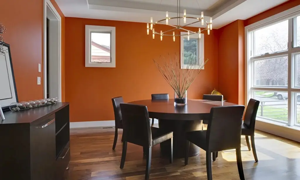 Rich orange wall paint with white window trim, and clean cut-in lines by an interior painter in Exeter, CA