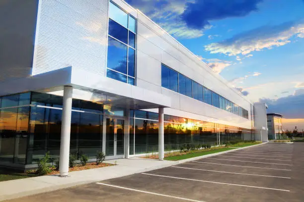 Commercial building with smooth white exterior paint and clean architectural trim by an exterior painting in Tipton, CA.