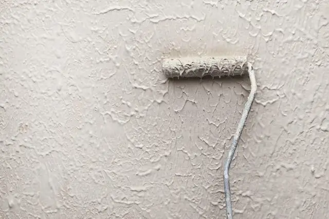 Textured wall receiving a fresh coat of paint showcasing drywall texturing by a house painter in Lemoore, CA